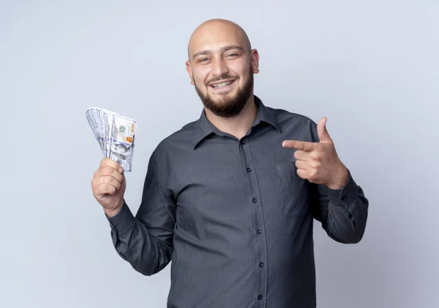 homem careca sorrindo ao segurar dinheiro do Empréstimo consignado CLT.